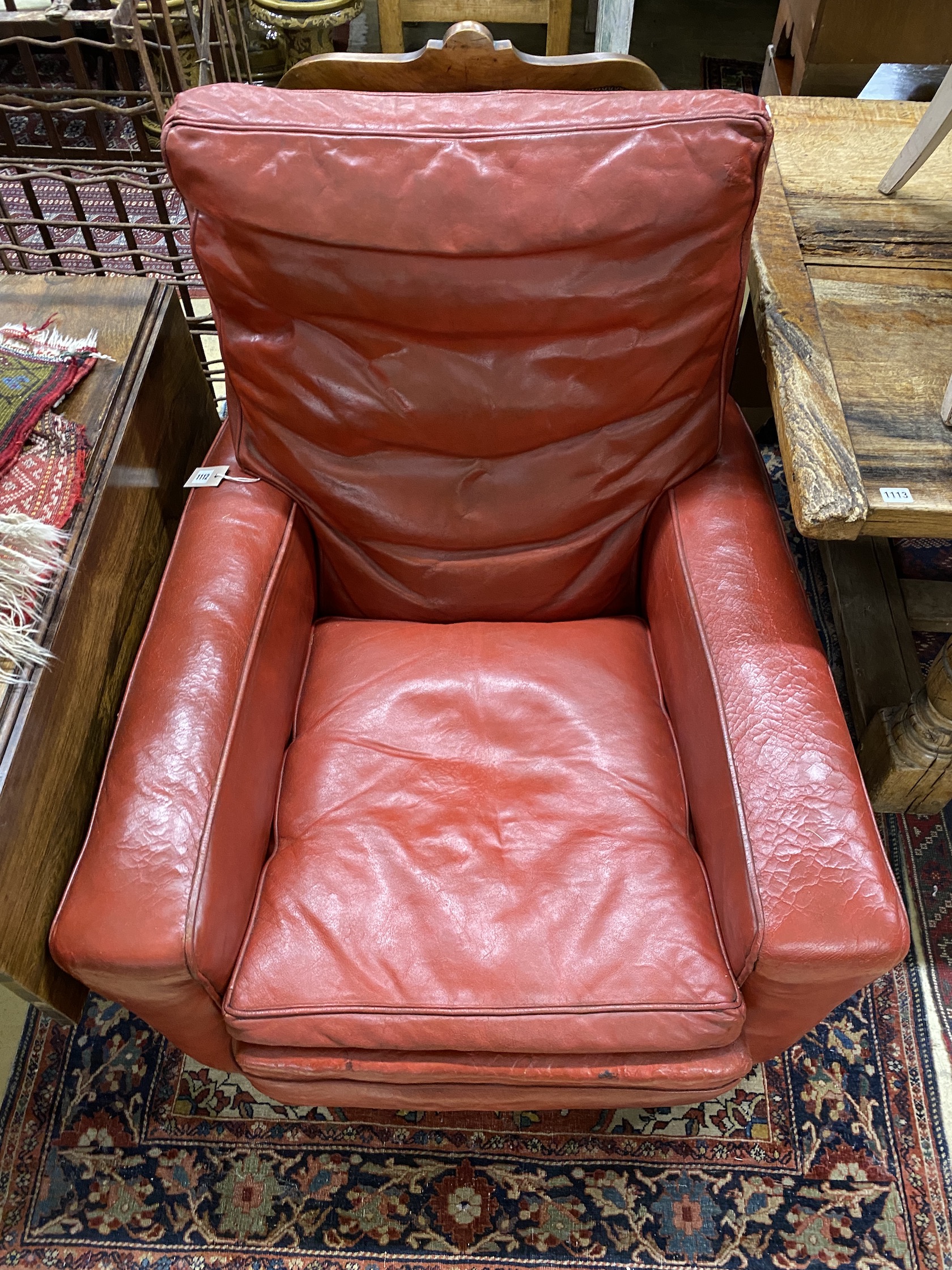 A red leather armchair, width 88cm, depth 86cm, height 100cm